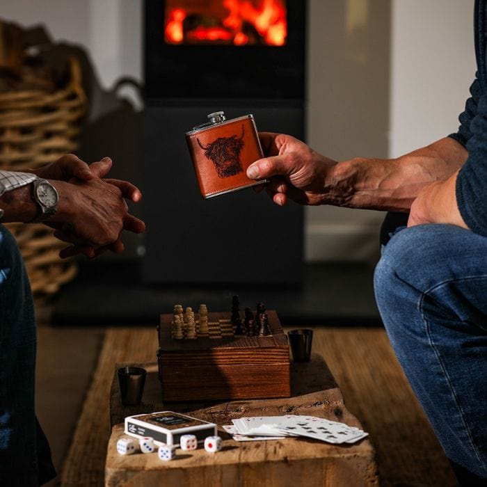 In this photo Highland Cow Engraved Hip Flask Game Set – Rugged Charm Meets Classic Fun Mood4whisky