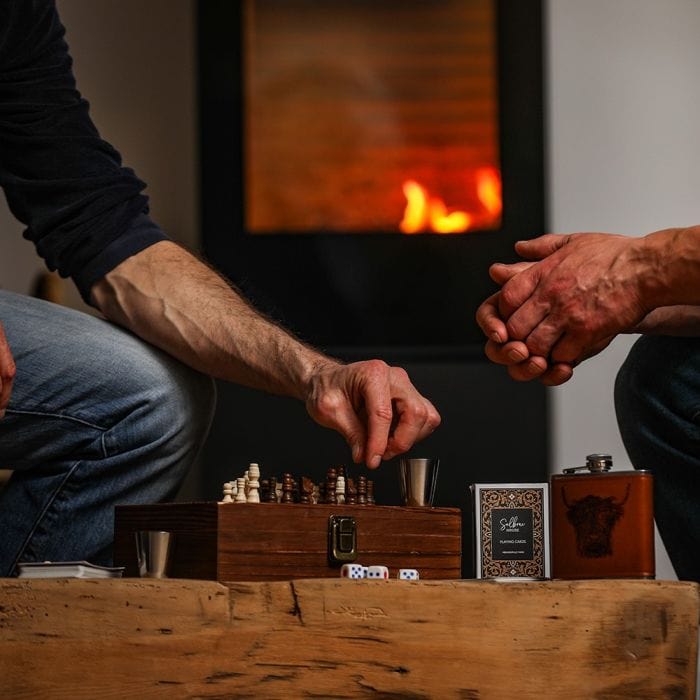 In this photo Highland Cow Engraved Hip Flask Game Set – Rugged Charm Meets Classic Fun Mood4whisky